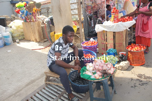 Kofi-Boye Philip Tetteh vending tomatoes, onions