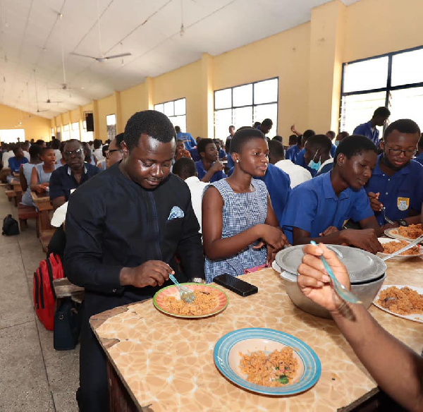 Reverend John Ntim Fordjour dining with the students