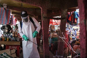 A staff member of Kenya's Ministry of Health sprays disinfectant to curb the spread of the coronavir