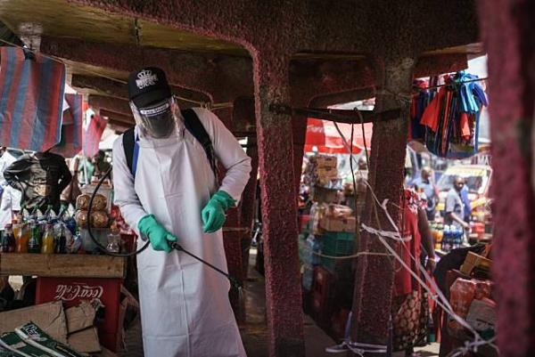 A staff member of Kenya's Ministry of Health sprays disinfectant to curb the spread of the coronavir