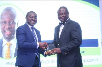 Chief Executive Officer of Universal Merchant Bank, Mr. John Awuah (R) picking up his award