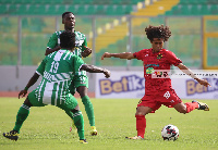 Asante Kotoko midfielder, Fabio Gama(Red) in action against King Faisal