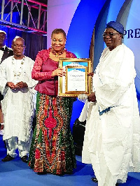 Mr Wale Adeoye-Famosa (R), CEO/MD of Primus Advertising Ltd, receiving certificate and citation