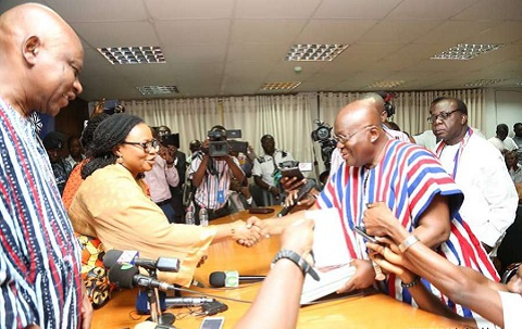 President Akufo-Addo and Madam Charlotte Osei exchanging a handshake