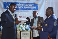 Lions District Governor, Dr. Kwabena Mensa-Bonsu presenting the Charter to Edward Adzimah