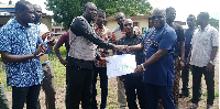 Edward Owusu (right) presenting the building plan to the contractor