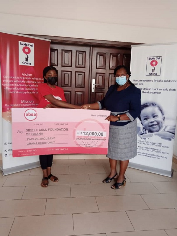 Ms. Chloe Elinam Mawuenyega presenting a cheque of GH12,000 to Mrs. Gifty Jecty