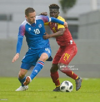 Gylfi Sigurdsson and Ghana's Opoku in a tussle for the ball