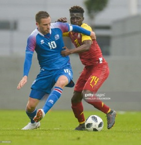 Gylfi Sigurdsson and Ghana's Opoku in a tussle for the ball