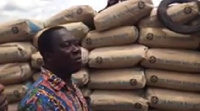 Alex Incoom presenting bags of cement to the Asene Salvation Army Primary School