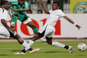 Former Black Stars players, Osei Kuffour and John Paintsil in action against Nigeria