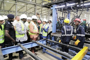 Alan Kyerematen with some dignitaries at a factory