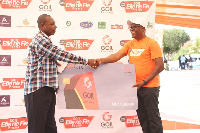 Mr. Benjamin Torkornoo, Head of Operations, Goil presenting one of the Ultimate rewards to a winner