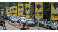 Billboards of Uganda's President Yoweri Museveni are seen on a street in Kampala (AFP)