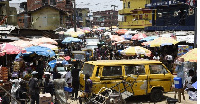 People walk around Mushin's Ojuwoye market in Lagos, in March 2020