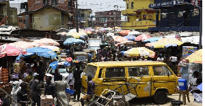 People walk around Mushin's Ojuwoye market in Lagos, in March 2020