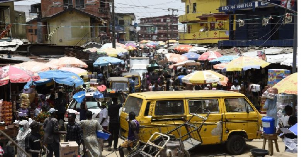 People walk around Mushin's Ojuwoye market in Lagos, in March 2020