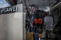 People visit the stand of Chinese telecom giant Huawei during the Web Summit in Lisbon