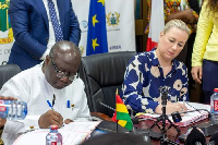 Finace Minister, Ken Ofori Atta, (left) signs the document for the agreement