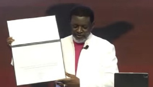 Agyinasare Showing The Certificate Of The Lifetime Award To His Congregation 