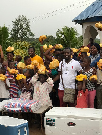 Sampson Ntiamoah in white lacoste with the beneficiaries