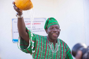 Lamtiig Apanga with a calabash of water after the inaugurationover