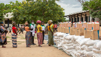 Women await in line during an United Nations World Food Program's distribution