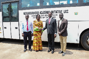 Minister Osei Adutwum (second right) hands over the bus to UCC officials