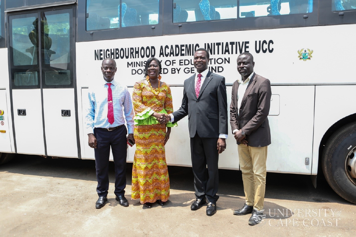 Minister Osei Adutwum (second right) hands over the bus to UCC officials