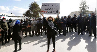 A demonstrator holds up a sign during an anti-government protest in Tunis, (REUTERS/Zoubeir Souissi)