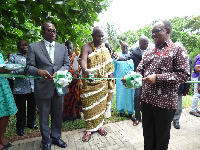 Major Tara, others, assisting Nii Kwabena Bonnie to commission the NTHC head office building.