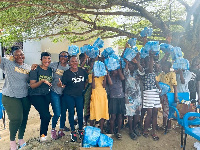 Children displaying the pads they received from PoP