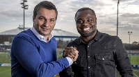 Grald Asamoah with an official of Schalke 04