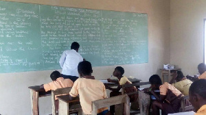 A teacher writing his exams questions on board (File photo)