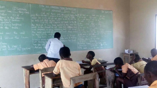 A teacher writing his exams questions on board (File photo)