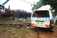 A breakdown truck towns away the wreckage of the commuter taxi, which killed 14 people