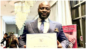 Dr. Michael K. Obeng with his letter signed by US president Joe Biden