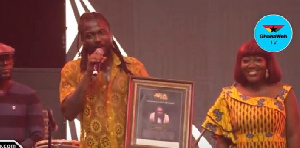 Samini holding his citation