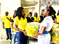 Adwoa Wiafe of MTN presenting hampers a Midwife at Korle Bu Teaching Hospital