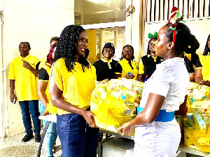 Adwoa Wiafe of MTN presenting hampers a Midwife at Korle Bu Teaching Hospital