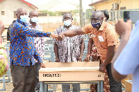 The DCE (third left) presenting some of the desks to the Education Directorate