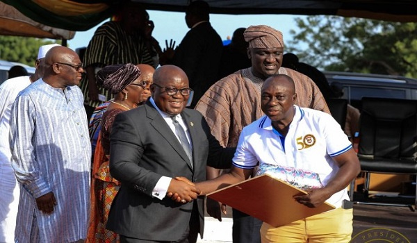 President Akufo-Addo presenting an award to a member of staff