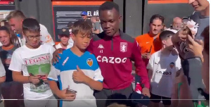 Owusu Amando in (tracksuit) taking pictures with the Valencia fans