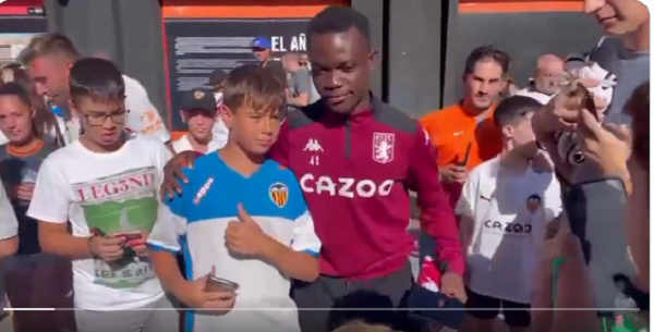 Owusu Amando in (tracksuit) taking pictures with the Valencia fans