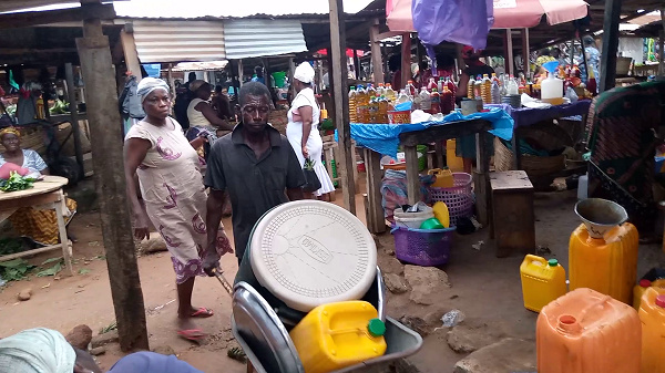 Tutu Kojo Angmor going about his regular hassle in the market