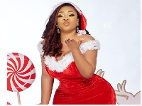 Moesha Boudong clad in a Christmas-themed outfit