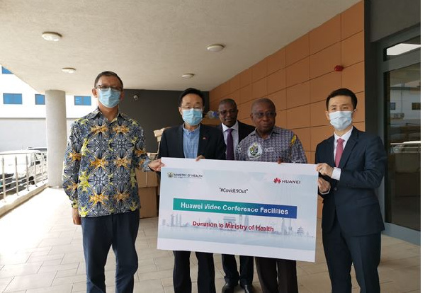 Health Minister Kwaku Agyeman Manu receiving the donation from some Huawei Executives