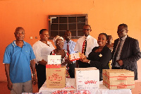 Mrs. Obuobi [second right] presents the items to the inmates of the Weija Leprosarium