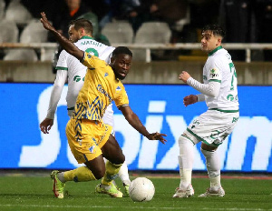 Kingsley Sarfo (in yellow jersey) battles for the ball