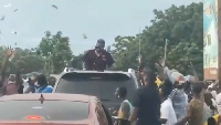 Dancehall artiste, Shatta Wale spraying money into a crowd